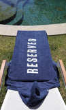 One Gun Ranch Kids Hooded Beach Towels. Blue terry cloth with Reserved printed in white text down the side. 