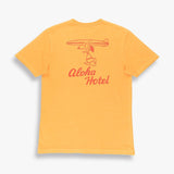 TSPTR. Yellow a design of snoopy holding a surfboard over his head. The words aloha hotel written underneath it in red