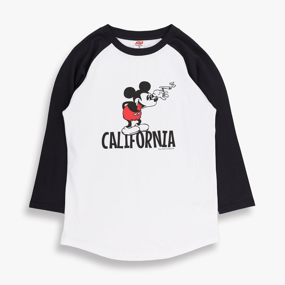 White baseball shirt with black sleeves. On the front is a design of mickey Mouse. and the word California underneath him. TSPTR brand