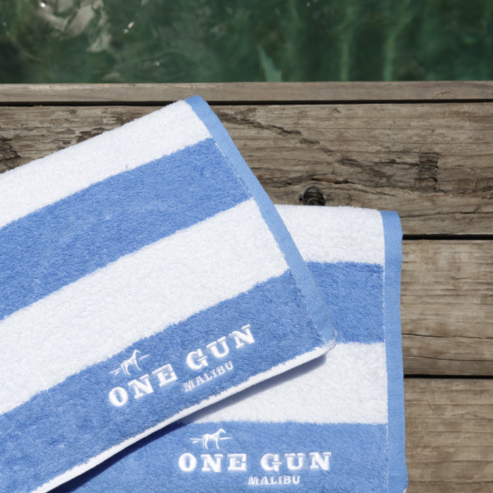 One Gun Malibu Cabana Beach Towels. Blue and white striped design. 