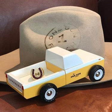 One Gun X Candylab Vintage Truck. The simple silhouette is made from solid beech wood, done up in a sunny hue with a band of banana-colored panelling, for a car thats as good looking as it is fun to play with. The wheels are made from durable rubber and feature ABS plastic rims. 
