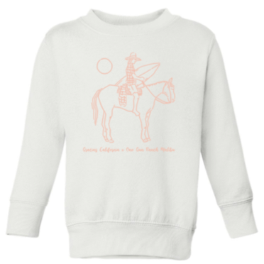 white sweatshirt with a pink outline drawing of a woman riding a horse and holding a surfboard. Underneath the text reads gracias california X one gun ranch malibu