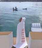 One Gun Adult Hooded Beach Towels. The towel is white with Malibu written in pink text