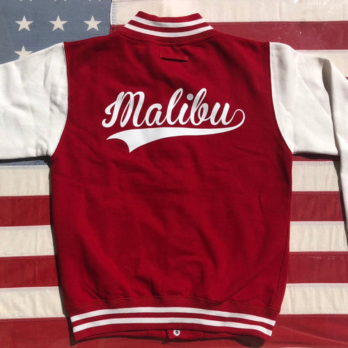 On The Rise Malibu Varsity Jacket. A red jacket with white sleeves. Malibu written in white cursive text across the back. 