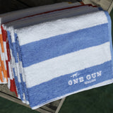 One Gun Malibu Cabana Beach Towels. Blue and white, red and white, orange and white, yellow and white stripped designs. 