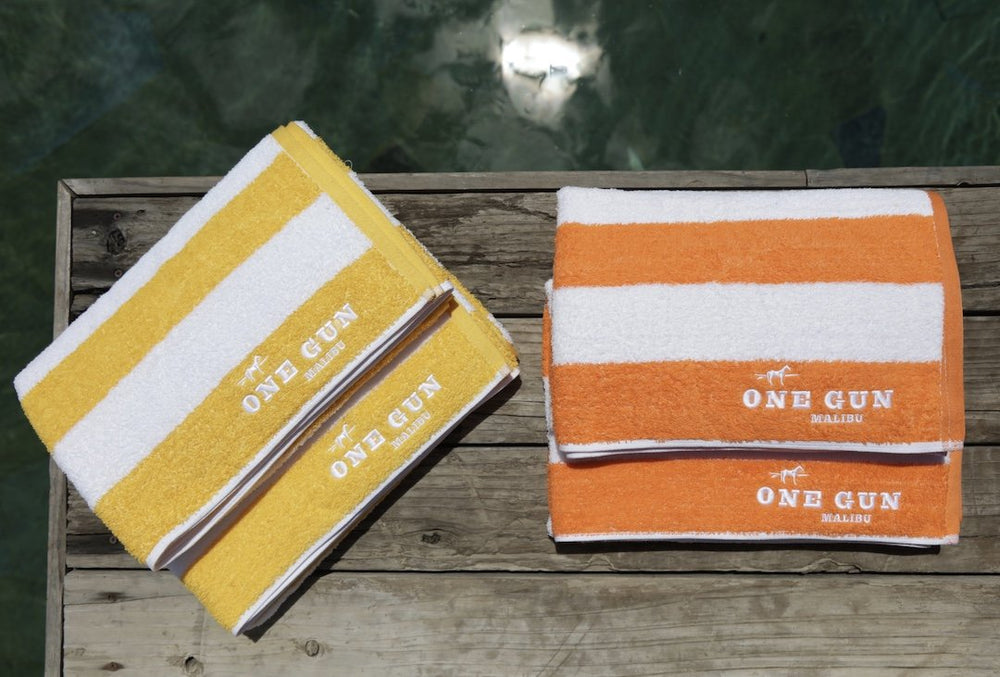 One Gun Malibu Cabana Beach Towels. Yellow and white and orange and white stripped design. 