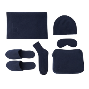 A navy Bamford travel blanket set. A large blanket, slippers, socket, a beanie, eye mask, and travel bag. 