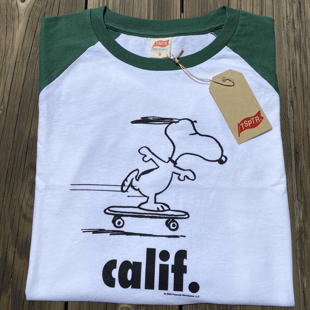 Green sleeved Peanuts Calif Raglan with a design of snoopy skateboarding