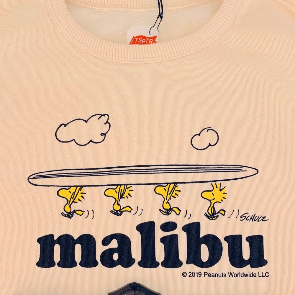 TSPTR Woodstock Sweatshirt. A light yellow sweatshirt with a design of four woodstocks holding a long board above their heads. The word Malibu underneath them. 