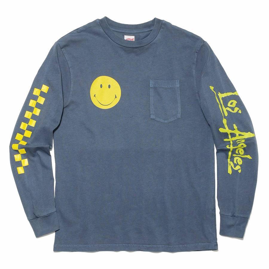 TSPTR Skate Or Die Long Sleeve T-Shirt. Gray long sleeve shirt with a yellow smiley face on the right side, a pocket on the left side. Yellow checkers on the right arm sleeve, and the words Los Angeles on the left sleeve. 