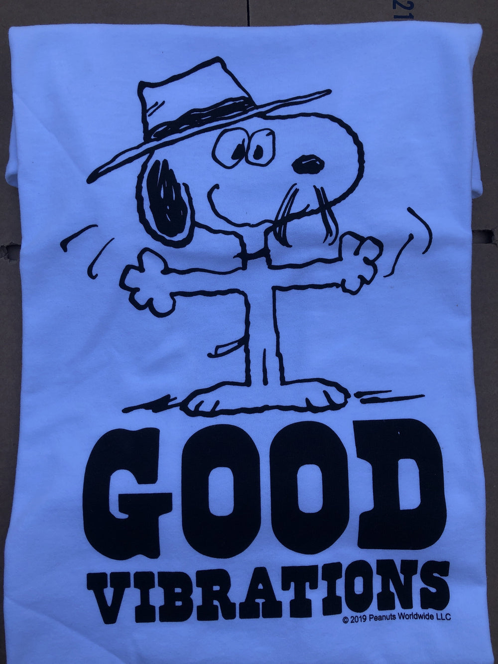 TSPTR Good Vibrations T-Shirt. White shirt with the design of snoopy wearing a fedora and the words Good Vibrations undenath