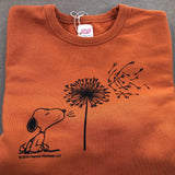 TSPTR My Reality Pullover. Orange sweater with a design of Snoopy blowing a dandelion flower. 