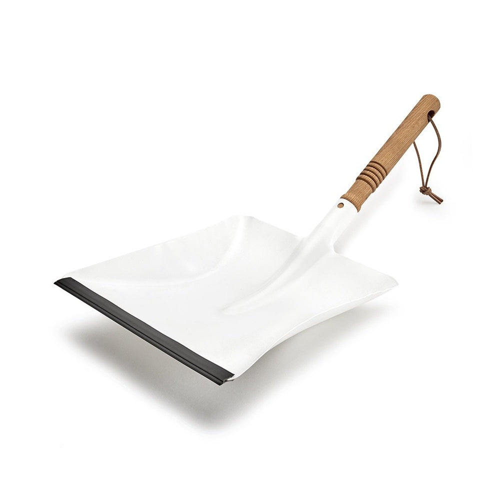 A white daylesford dust pan with a wooden handle and leather string strap. 
