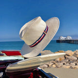 Gladys tamez Peck white hat with a red white and blue strip around the brim. 100% panama straw hat with striped grosgrain band  Measurements: Brim - 3"