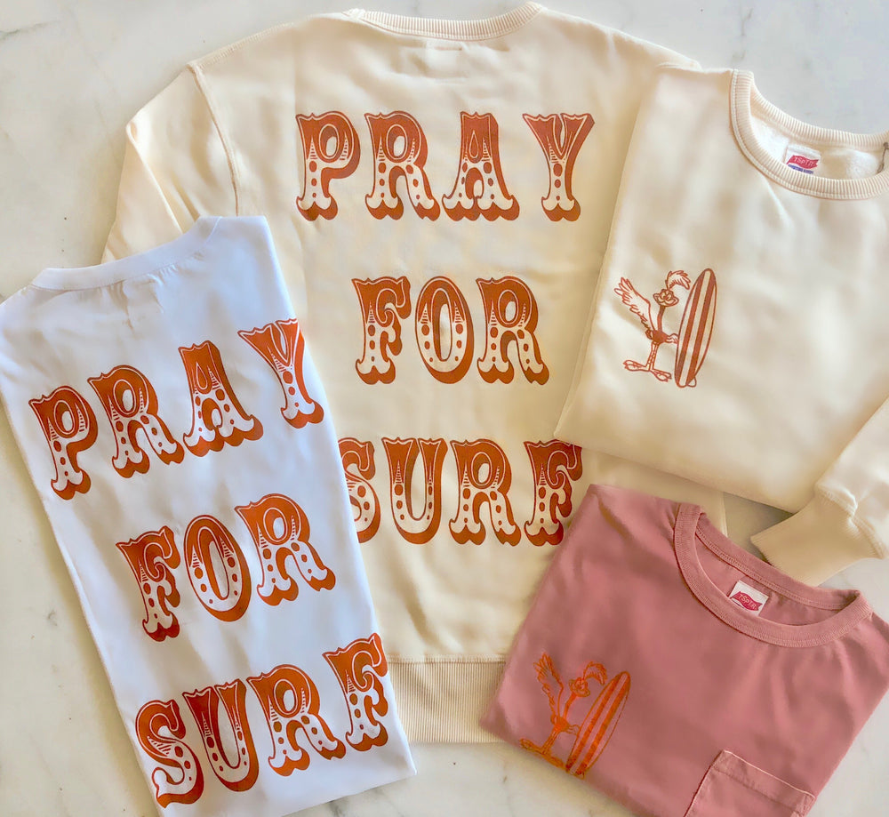 TSPTR PRAY FOR SURF Sweatshirt. A white sweater with the words Pray For Surf from top to bottom. 