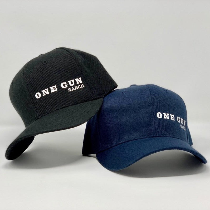 Blue and black hat with the logo One Gun Ranch in white text.