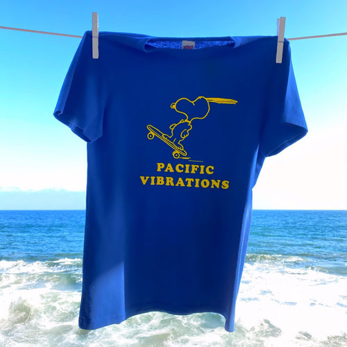 Blue Peanuts Pacific Vibrations T-Shirt with a design of snoopy skateboarding