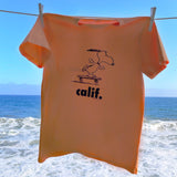 Orange Peanuts Calif T-Shirt with a design of snoopy skateboarding. 