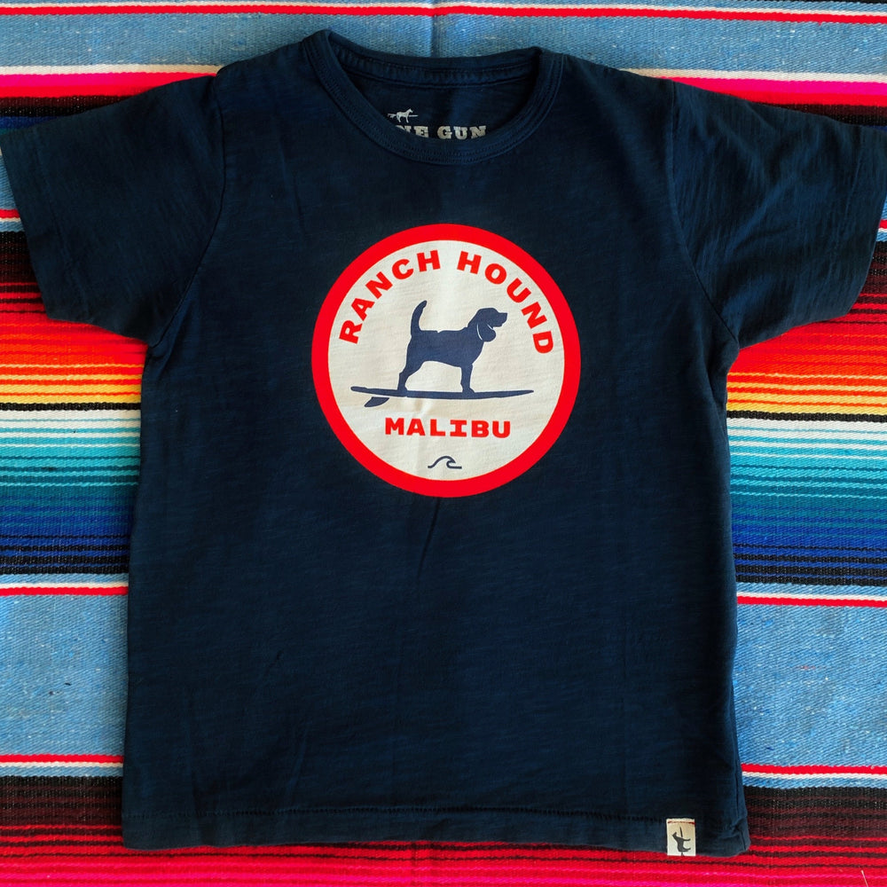 One Gun Ranch Hound Malibu Kids T-Shirt. 100% cotton. Made in Los Angeles. Blue shirt with a red white and blue design in the center. 