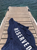 One Gun Adult Hooded Beach Towels. The towel is blue with Reserved written in white text