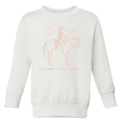 Kids white sweatshirt with a pink outline drawing of a woman riding a horse and holding a surfboard. Underneath the text reads gracias california X one gun ranch malibu